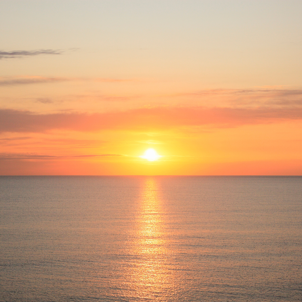 Warm orange sunset over the sea horizon